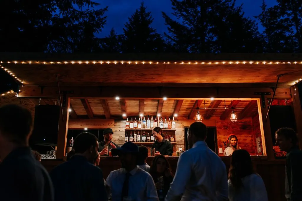 Guests at the lit-up Whistler Boombox mobile bar at night